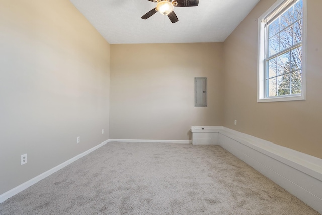 carpeted spare room with electric panel and ceiling fan