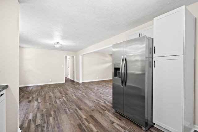 kitchen with white cabinetry, stainless steel fridge with ice dispenser, dark wood-type flooring, and a textured ceiling