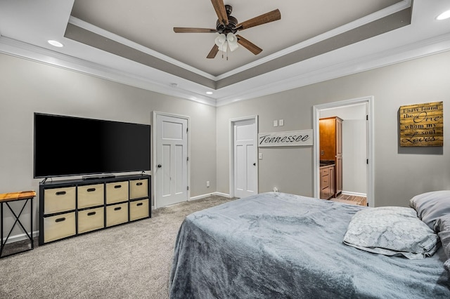 bedroom with ceiling fan, a raised ceiling, and ornamental molding