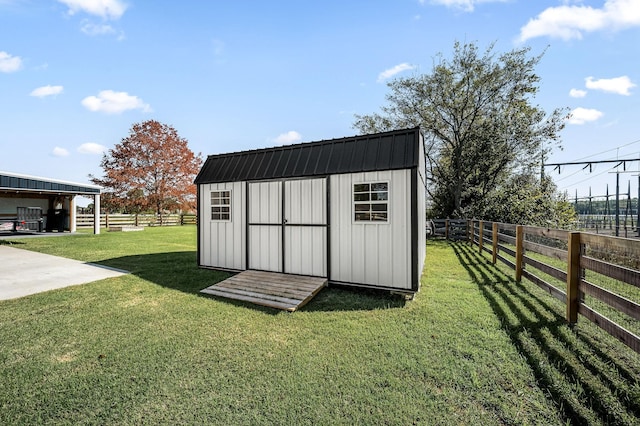 view of outdoor structure featuring a lawn