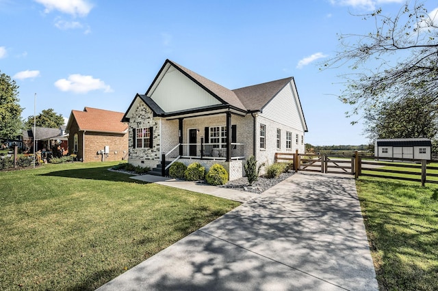 view of front of house featuring covered porch and a front lawn