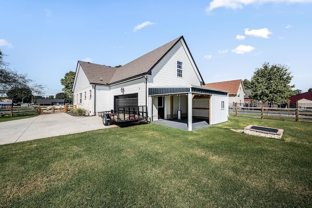 back of house featuring a patio area and a lawn