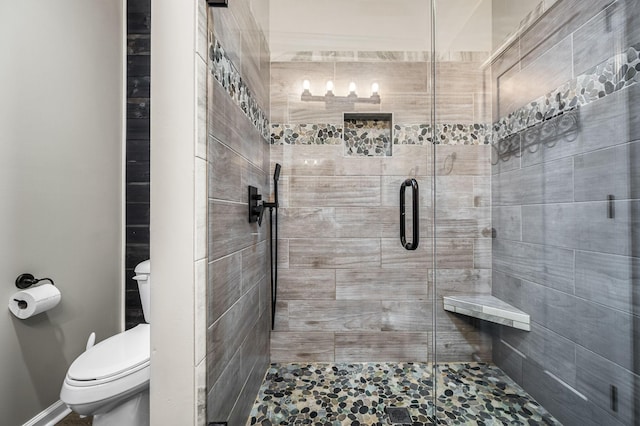 bathroom featuring walk in shower and toilet