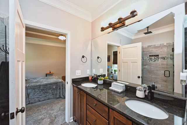 bathroom with vanity, a shower with door, and ornamental molding