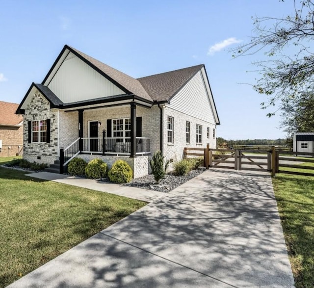 view of side of home featuring a lawn and a porch