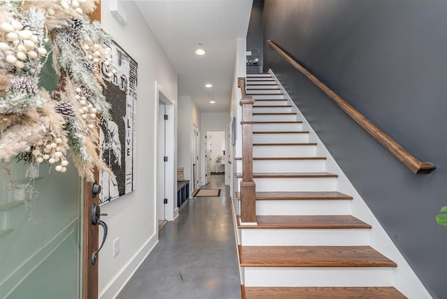 staircase featuring concrete floors