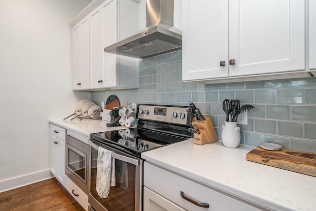 kitchen with white cabinetry, wall chimney exhaust hood, light stone counters, backsplash, and stainless steel electric range