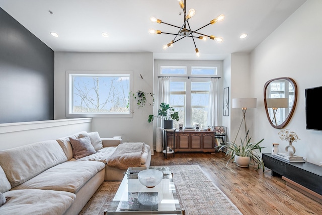 living room featuring hardwood / wood-style floors and a notable chandelier