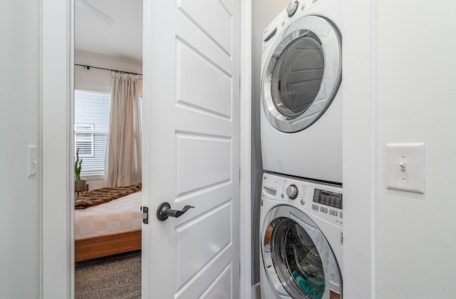 laundry room with stacked washing maching and dryer and carpet floors