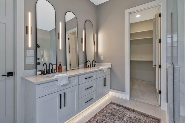 bathroom featuring a shower, tile patterned flooring, and vanity