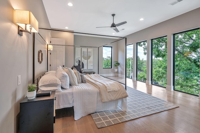 bedroom with ceiling fan, light hardwood / wood-style floors, and access to exterior