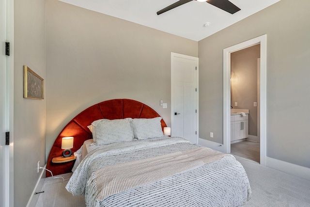 carpeted bedroom featuring ceiling fan and connected bathroom