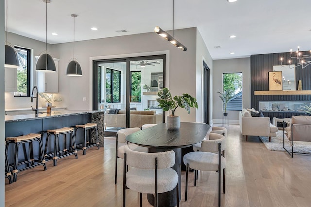 dining area with visible vents, a fireplace, and a wealth of natural light