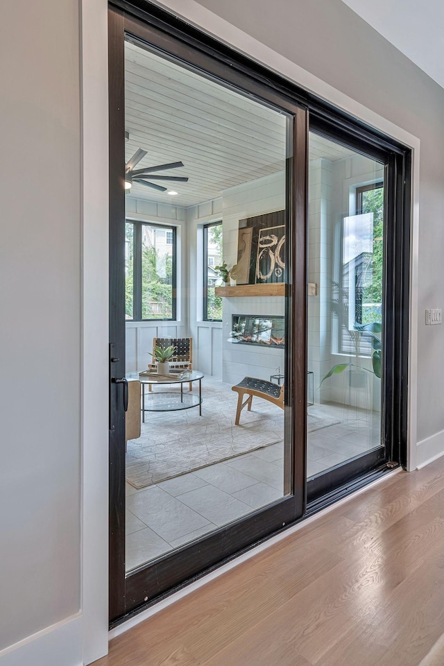 doorway to outside with hardwood / wood-style floors and ceiling fan