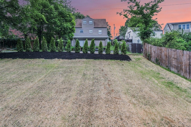 view of yard at dusk