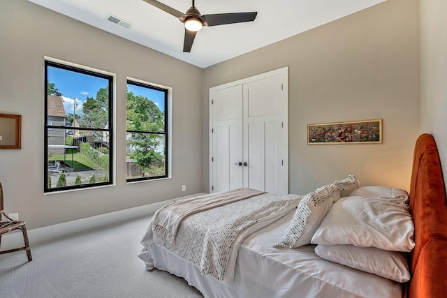 bedroom with carpet flooring, ceiling fan, and a closet