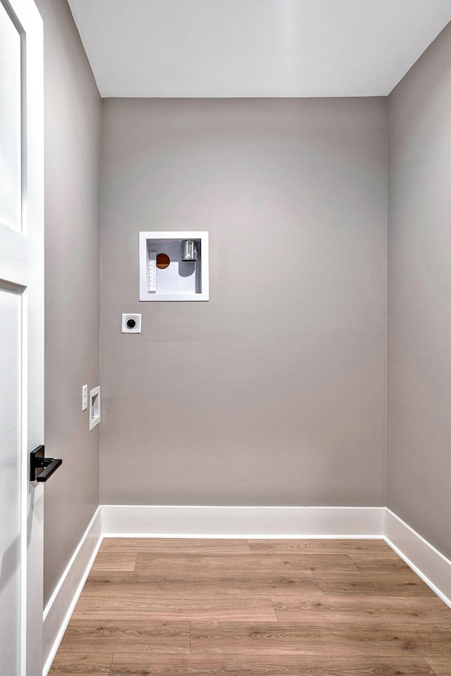 laundry area featuring washer hookup, electric dryer hookup, and light wood-type flooring