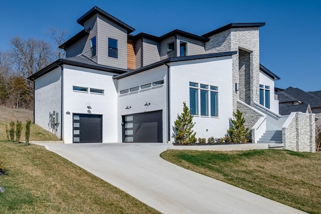 contemporary house featuring a front yard and a garage