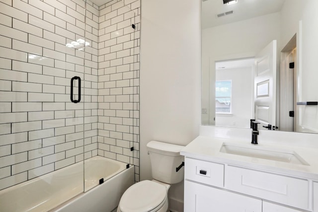 full bathroom with vanity, toilet, and bath / shower combo with glass door