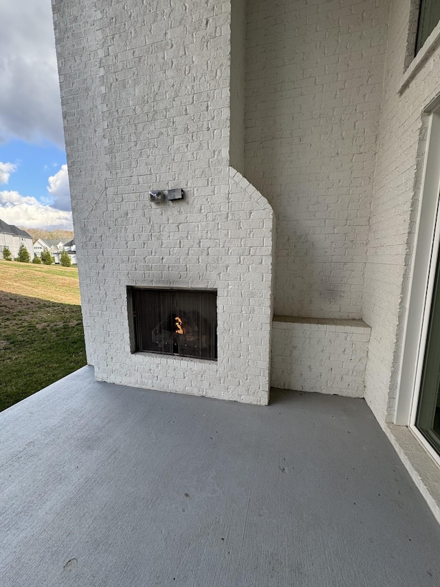 exterior details with an outdoor brick fireplace