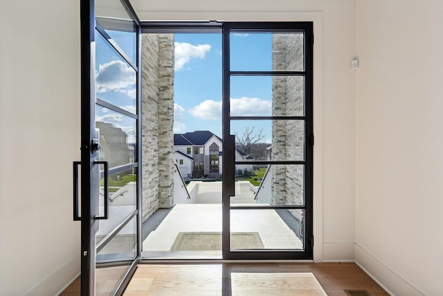 doorway with hardwood / wood-style floors