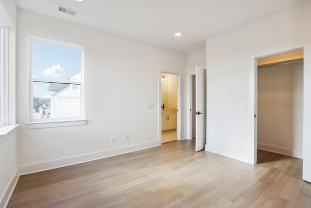 unfurnished bedroom with light wood-type flooring