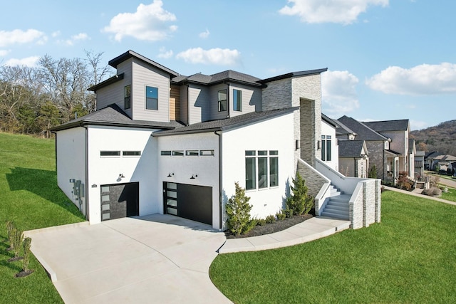 view of front of home with a garage and a front yard