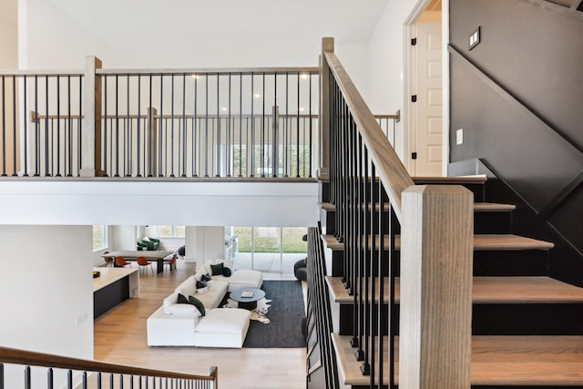 stairs featuring plenty of natural light and hardwood / wood-style floors