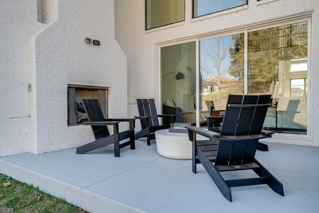 view of patio with an outdoor fireplace