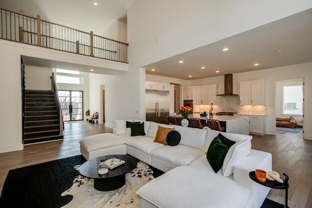 living room featuring dark hardwood / wood-style floors and a high ceiling