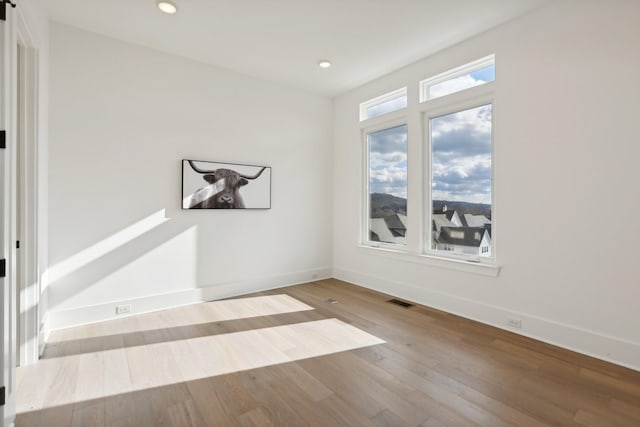 spare room featuring light hardwood / wood-style floors