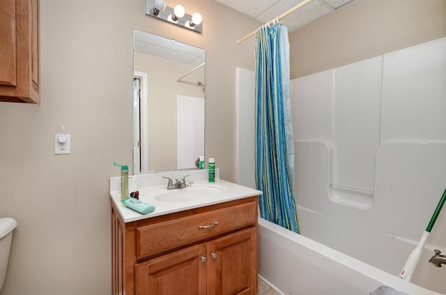 full bathroom featuring a paneled ceiling, vanity, toilet, and shower / bath combo with shower curtain