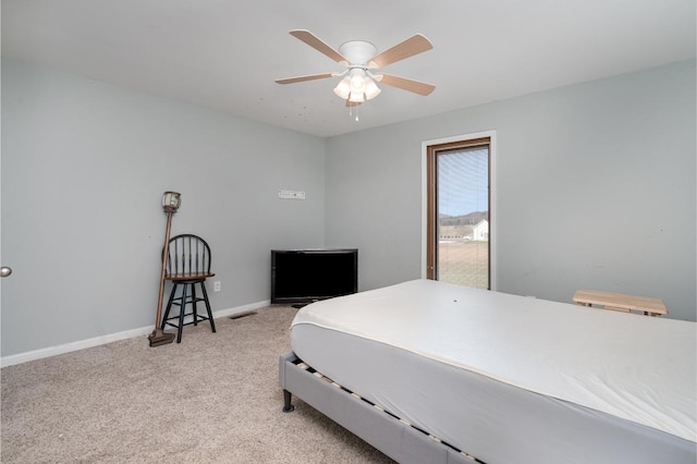 bedroom with ceiling fan and light carpet