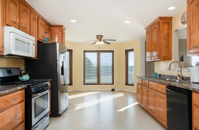 kitchen featuring sink, black dishwasher, ceiling fan, and stainless steel range with gas stovetop