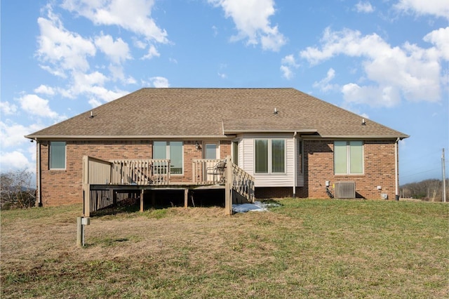 rear view of house featuring a yard and a wooden deck