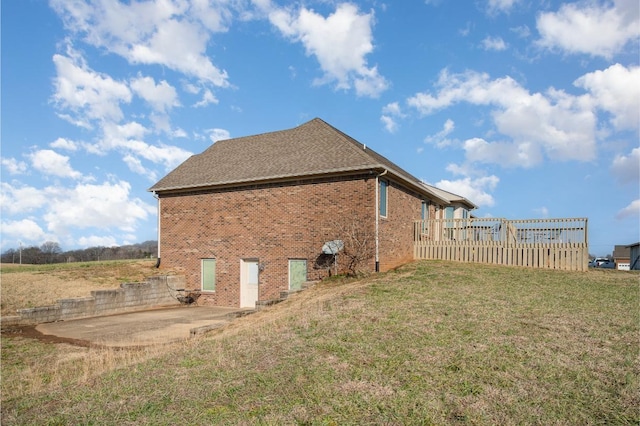 view of property exterior with a yard and a patio