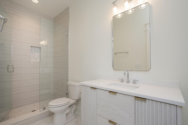 bathroom featuring vanity, toilet, and a shower with shower door