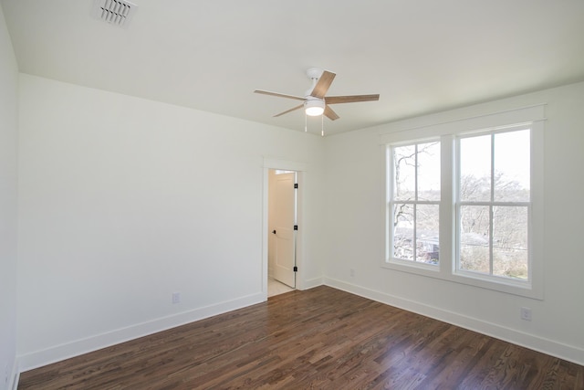 unfurnished room with ceiling fan and dark hardwood / wood-style flooring