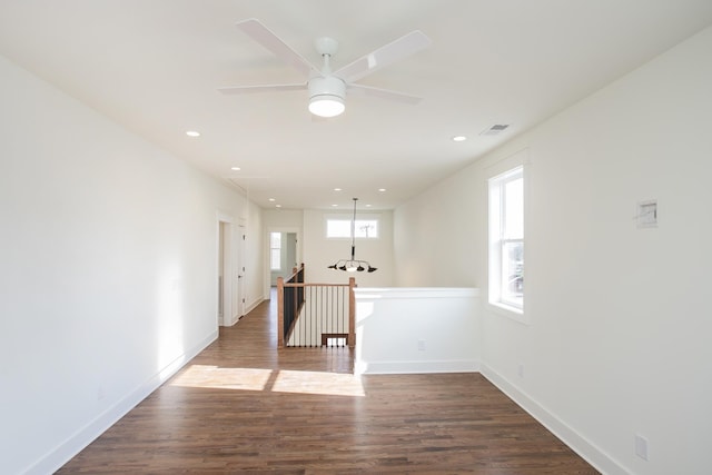 empty room featuring ceiling fan and dark hardwood / wood-style flooring