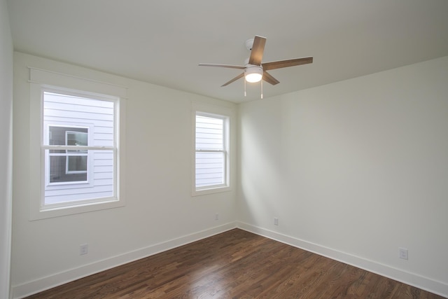 empty room with dark wood-type flooring and ceiling fan