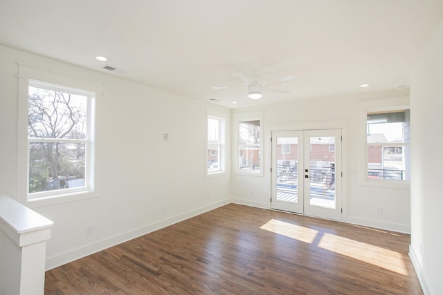 empty room with french doors, ceiling fan, wood-type flooring, and a wealth of natural light