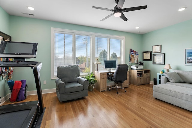 home office with ceiling fan and light hardwood / wood-style flooring