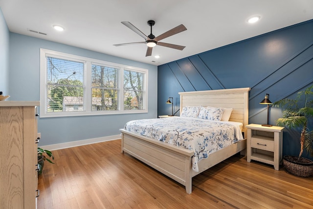 bedroom featuring light hardwood / wood-style floors and ceiling fan