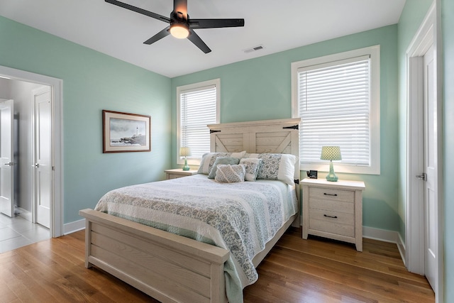 bedroom with ceiling fan and hardwood / wood-style floors