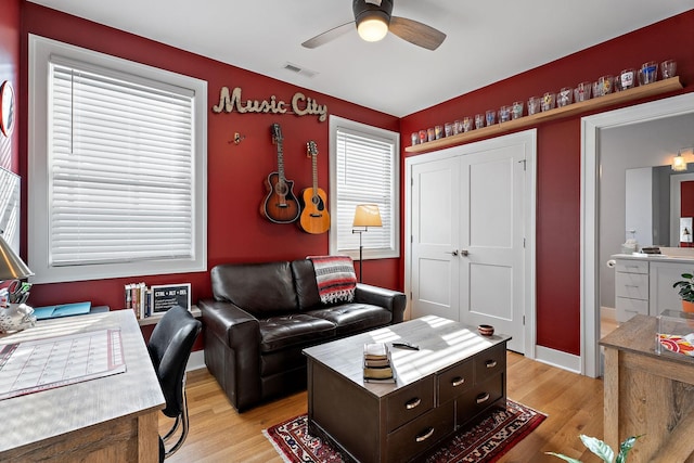 living room featuring ceiling fan and light wood-type flooring