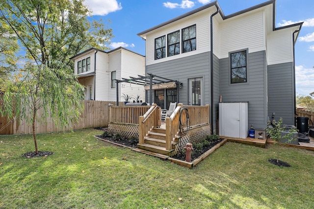 rear view of house with a pergola, a yard, and a wooden deck