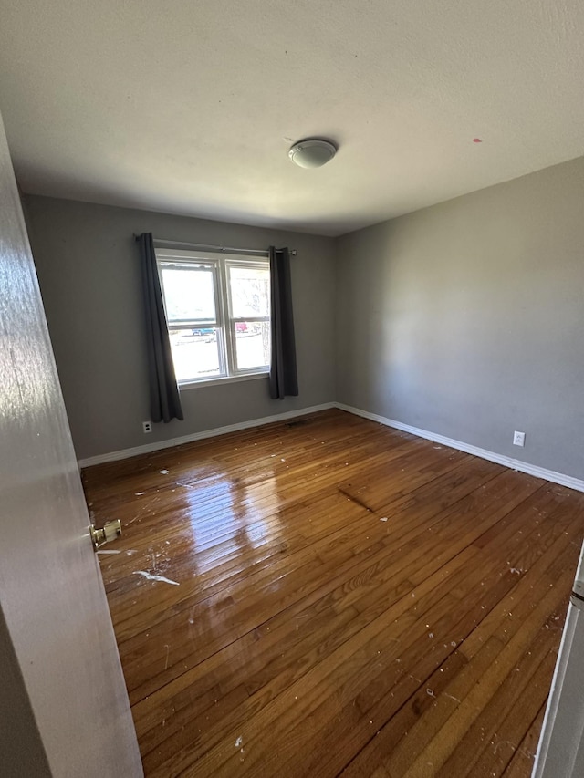 spare room featuring hardwood / wood-style floors