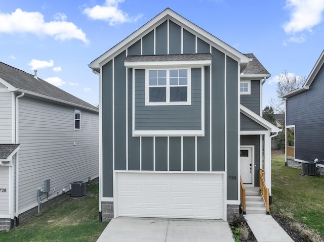 view of front of house featuring a front lawn, a garage, and cooling unit