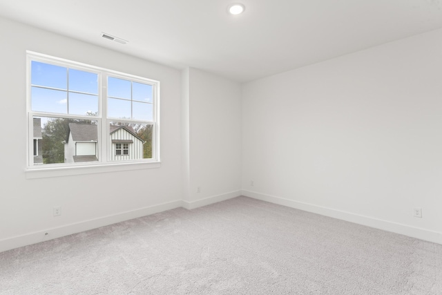 unfurnished room featuring a wealth of natural light and carpet flooring