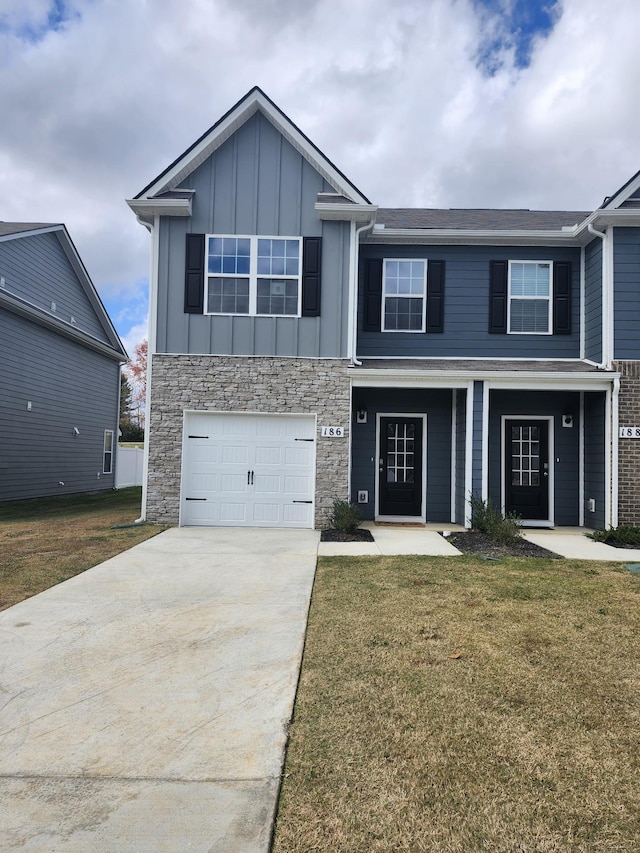 view of front of home with a front lawn and a garage